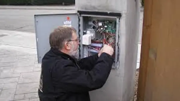 Technician maintaining an automated gate system